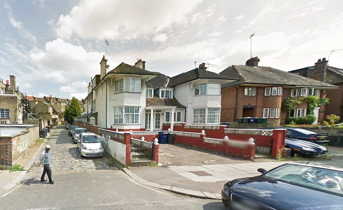 Hodford Road white two semi-detached houses with double fronted bay windows on road junction NW11