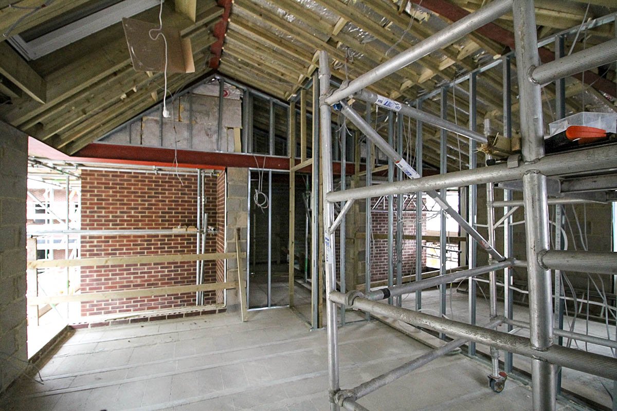 internal vaulted roof construction Hodford Road with timber rafters and SFS stud partition walls with scaffold tower and electric cables