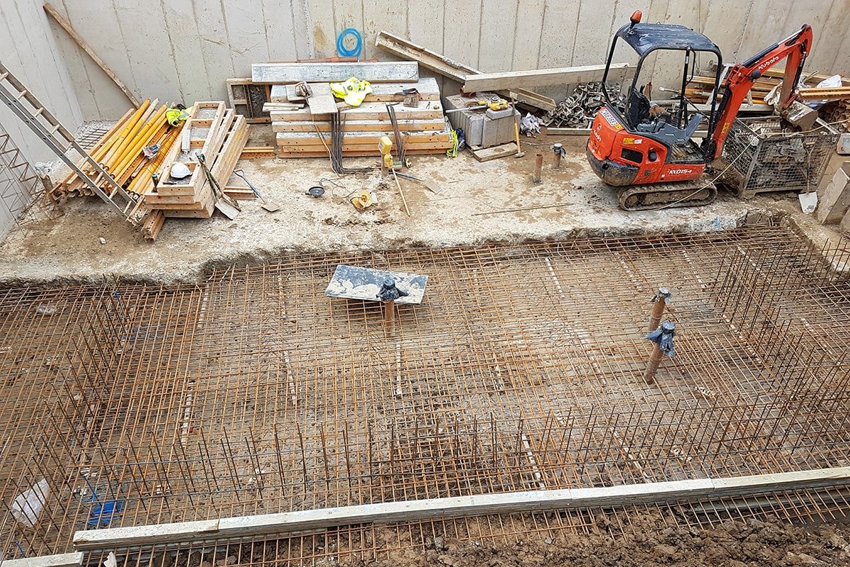 Hodford Road steel reinforcement ready for concrete pour adjacent to completed concrete retaining wall and slab with temporary formwork