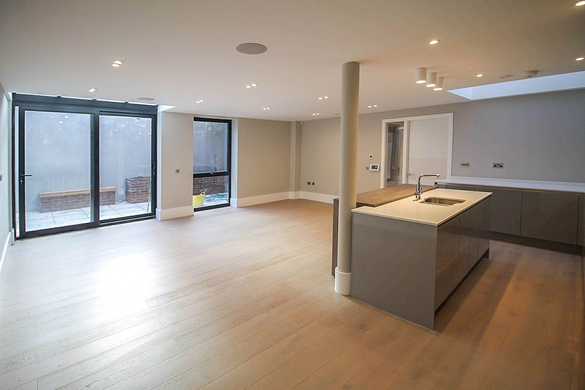 open-plan kitchen and lounge Hodford Road with up-and-over window slising door, skylight and central circular column