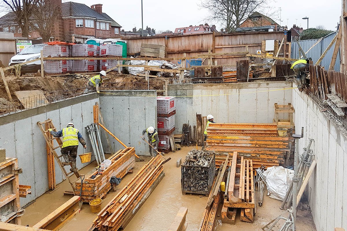 cast concrete basement Hodford Road excavated with yellow temporary formwork and steel supports with 5 construction workmen