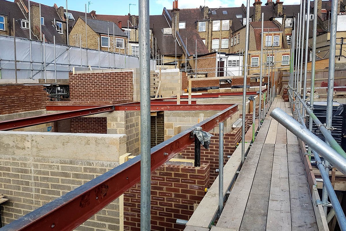 Hodford Road red steel beams on brick and blockwork walls surrounded by neighbouring old yellow brick buildings